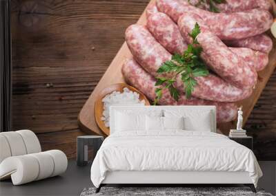 Raw sausages on the wooden board Wall mural