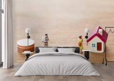 selective focus of miniature angry woman with miniature man and mini house,stack coins on wooden  background for Asset management after divorce concept. Wall mural