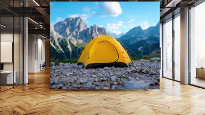 A vibrant yellow tent set against a stunning mountainous landscape, perfect for camping adventures and outdoor exploration. Wall mural