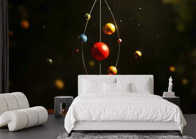 A physics-inspired model of colorful, floating spheres orbiting in a delicate balance, representing planetary motion or atomic structure, suspended in mid-air, symbolizing harmony and cosmic energy. Wall mural