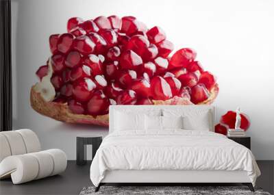 piece of ripe pomegranate with few separate ceeds isolates on white background Wall mural