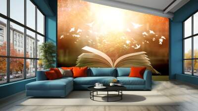 Images of ancient books open on wooden tables with beautiful overlays for illustration and background images. Wall mural