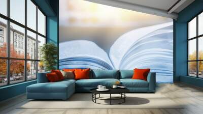 Imagine a picture book of an ancient book opened on a wooden table with a sparkling golden background. With magical power, magic, lightning around a glowing glowing book In the room of darkness Wall mural