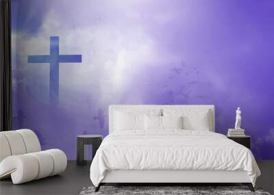 The Christian cross looks bright in the purple sky, with soft white clouds and beautiful light which leads to peace and heaven. Wall mural