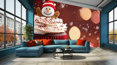 A festive cupcake topped with a snowman decoration, perfect for holiday celebrations and Christmas treats. Wall mural