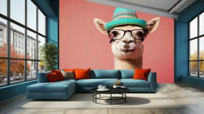 Lama in a bright hat and stylish glasses, against the background of a pink wall, vintage and fashionable style. Isolated studio portrait close up. Funny, cute and unusual image. Wall mural