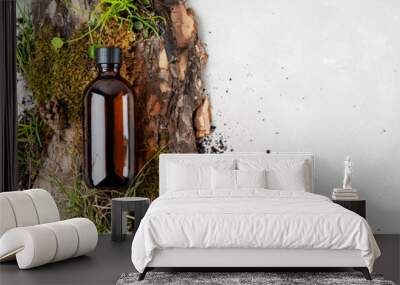 Beauty natural background with bark tree, tiny mosses and grass of organic cosmetic products in glass brown bottle. Flat lay, Wall mural