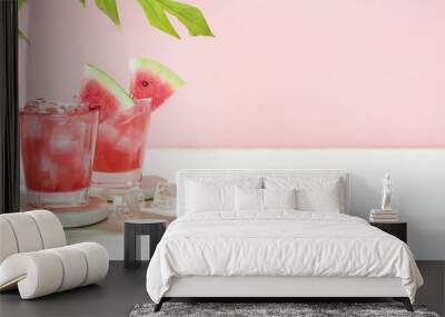 Fresh summer cocktail watermelon juice with ice in a two glass and glass straw on pink background. Layout for wide banner with space for text. Wall mural