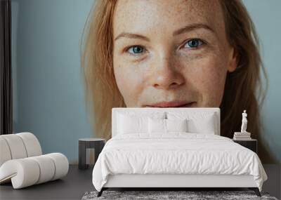 Beautiful woman with read hair and freckles. Close up portrait against black background Wall mural