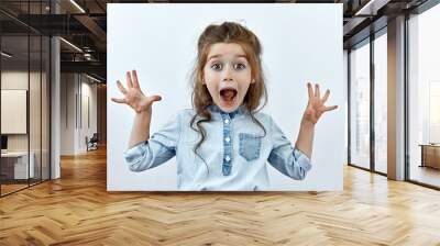 Surprised,shock ,unbelievable emotion. Little girl face portrait agaist white backgraund. Wall mural