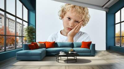 Tired,boredom and exhausted emotion. Little child boy portrait against white background Wall mural