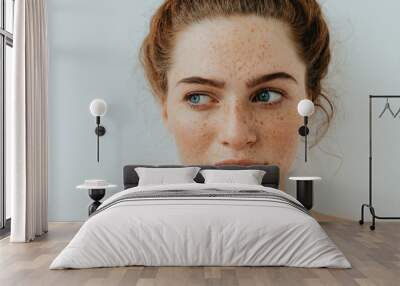 woman portrait. close-up. beautiful blue eyed girl with freckles is looking away, on a white backgro Wall mural