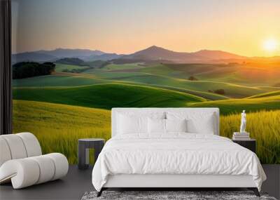 A breathtaking view of an idyllic green landscape featuring gently rolling hills bathed in the golden light of sunrise, presenting a tranquil and picturesque rural scene. Wall mural