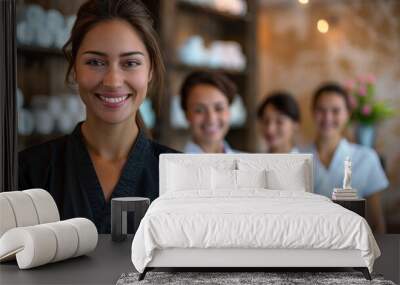 A smiling woman in spa uniform stands confidently with her team in the background Wall mural