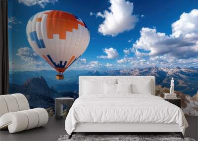 A vibrant hot air balloon soars above striking mountain ranges, representing a remarkable journey and the adventurous spirit, captured in stunning natural beauty and expansive views. Wall mural