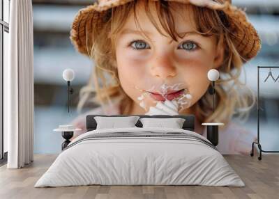 Curly-haired young girl licks ice cream cone with melting drops Wall mural