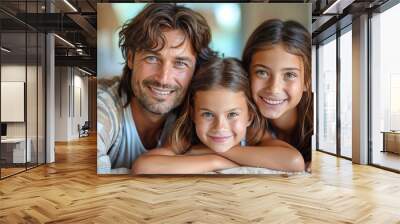 Father and two daughters smiling together in a happy family portrait Wall mural