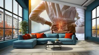  woman holding her lower back while and suffer from unbearable pain health and problems, chronic back pain, backache in office syndrome, scoliosis, herniated disc, muscle inflammation Wall mural