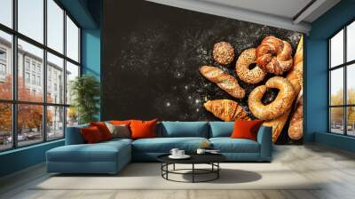 Bakery - bread rolls, baguette, bagel, sweet bun and croissant on black background Wall mural