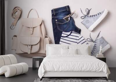 Clothing outfit - white backpack, jeans, striped t shirt, blue sneakers Wall mural