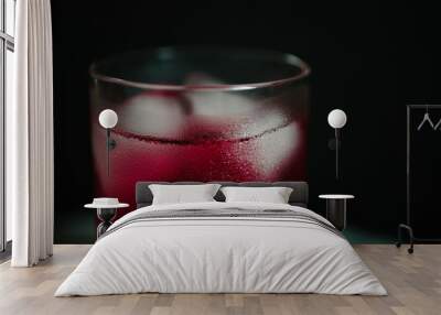 low key cold pink cocktail with ice cubes and condensed water on glass Wall mural