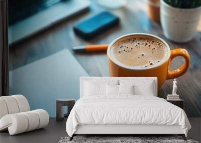 A cup of coffee on a work desk, with a notebook and pen in the background, symbolizing a quick coffee break. Wall mural