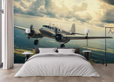 A vintage airplane flying over a scenic countryside, evoking nostalgia and the golden age of aviation Wall mural