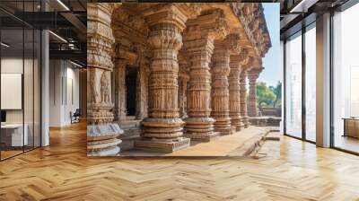 Grand architecture of an ancient temple, with massive columns and intricate carvings under a clear sky. Wall mural