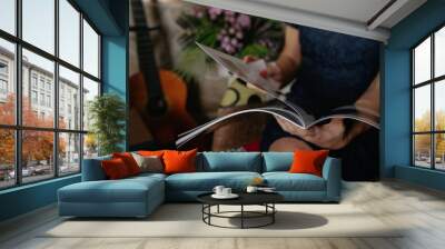 woman browsing a magazine Wall mural