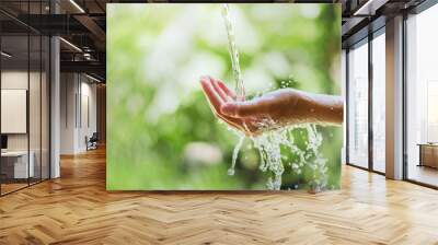 water pouring flow on woman hand  on nature background Wall mural