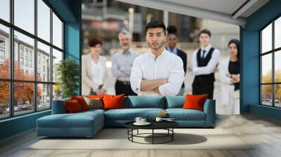 group of multiracial business people standing, focus on young asian man Wall mural