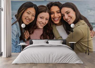 portrait of four diverse female friends on the beach Wall mural