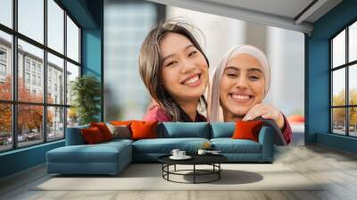 Portrait of two Asian Muslim businesswomen, Asian businesswomen or office workers, colleagues of diverse ethnic, intercultural and religious smiles accepting as colleagues in the organization. Wall mural