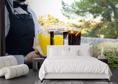 waiter carrying tray with glasses with soft drinks Wall mural