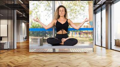 woman does yoga at bus stop Wall mural