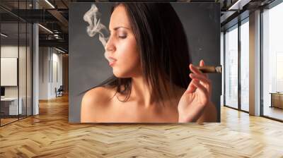 Portrait of woman smoking cigar. Studio fashion photo on dark ba Wall mural