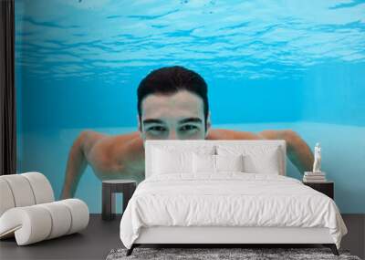 Smiling underwater man portrait inside swimming pool. Wall mural