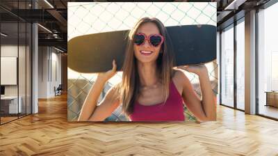 Teenager with skateboard close up portrait in the street against Wall mural