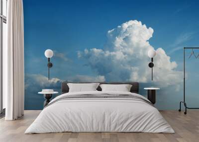 Wide shot of isolated clouds moving on blue sky Wall mural