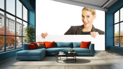 Businesswoman holding empty billboard Wall mural