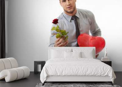 Man kneeling with red rose and heart balloon. Wall mural