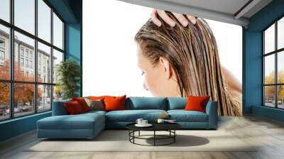 Photo of woman applying hair conditioner. Wall mural