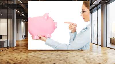 Woman pointing on piggy bank. Wall mural