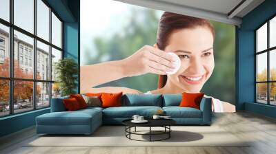 Woman removing make up. Wall mural