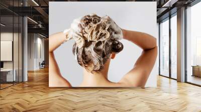 Woman washing her blond hair Wall mural