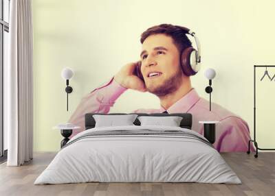 Young businessman listening to music. Wall mural