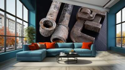 Old dirty pipe and hydraulic wrench. Accessories and tools for a plumber. Wall mural