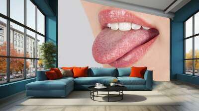 Young cheerful girl showing tongue Wall mural