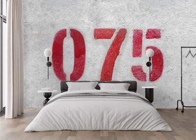 Red Number 075 on the white wall. Spray paint. Wall mural