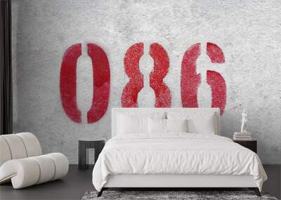 Red Number 086 on the white wall. Spray paint. Wall mural